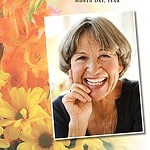 Beautiful memorial card with a smiling elderly woman and floral background.