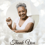 Elderly woman smiling and giving a thank you gesture for appreciation.