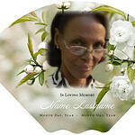 Obituary fan with a photo of a woman and white flowers for memorial.